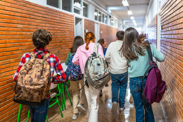 Students walking down school hallway between classes