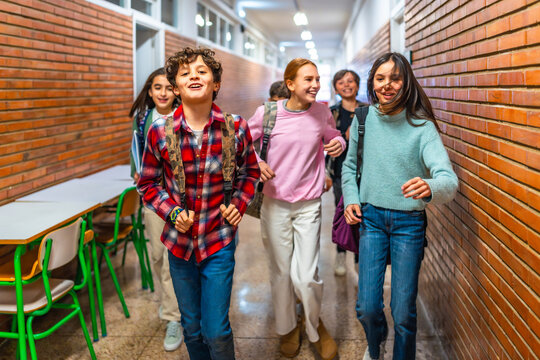 Group of students running in school hallway