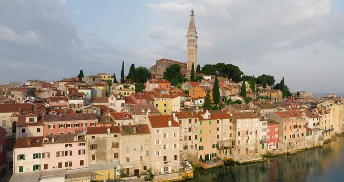 Rovinj City And Prominent Church of St. Euphemia With Bell Tower In Croatia. - aerial shot