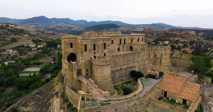 Exterior Of Medieval Castle In Rocca Imperiale With Mountain Views In Cosenza, Italy. - aerial shot