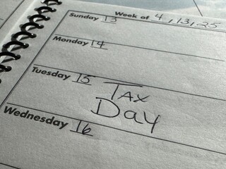 close up of a daily planner with Tax Day emphasized on April 15th