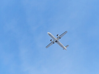 Plane in blue sky: overhead, under plane, signal fire.