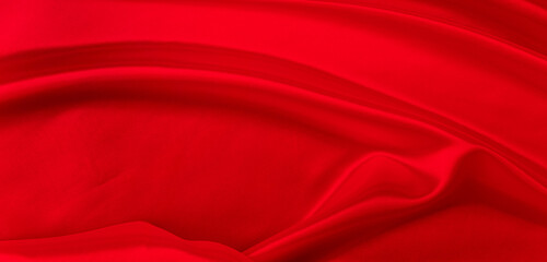 Black red satin dark fabric texture luxurious shiny that is abstract silk cloth background with patterns soft waves blur beautiful.