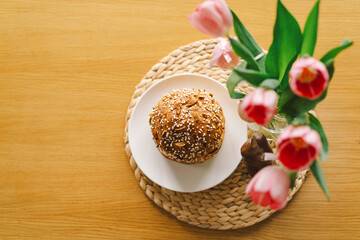 Beautifully decorated Easter cake topped with icing and chocolate sprinkles sits alongside a chocolate bunny and pastel eggs. The cheerful arrangement radiates holiday joy.