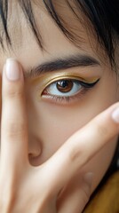 Naklejka premium Woman's eye, gold makeup, close-up, studio shot, beauty