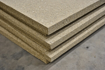 Stacked sheets of composite material ready for construction in workshop