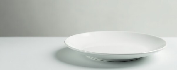 Fototapeta premium Clean empty white ceramic plate, minimalist design, ware, stock, isolated