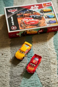 Mattel Cruz Ramirez and Lightning McQueen on a Trefl Disney Pixar Cars puzzle.