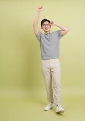 Young Asian business man on green background