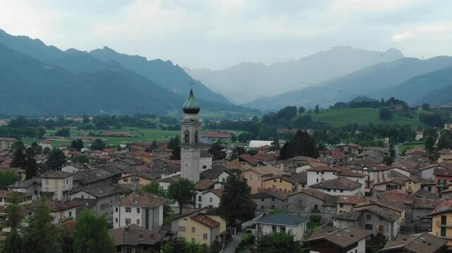 Rovetta village, mountains in background, Bergamo, Lombardy in Italy. Aerial forward