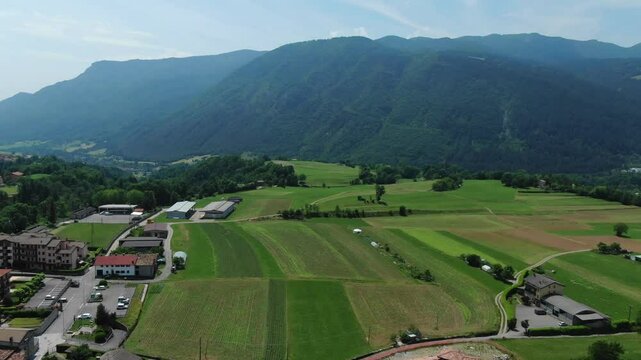 Clusone plateau, Rovetta, cultivated fields, Lombardy in Italy. Aerial forward