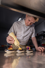 Chef garnishing small dishes