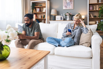 Gadget addiction and relationship problems. Couple with smart phones ignoring each other. Obsessed...