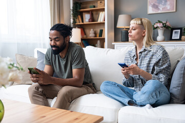 Gadget addiction and relationship problems. Couple with smart phones ignoring each other. Obsessed...
