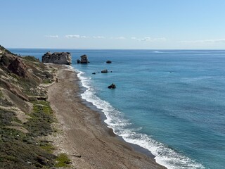 Scenic beach and rock formations in Cyprus. Mediterranean Sea, road, travel, view of mountains and sea.