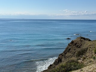 Scenic beach and rock formations in Cyprus. Mediterranean Sea, road, travel, view of mountains and sea.