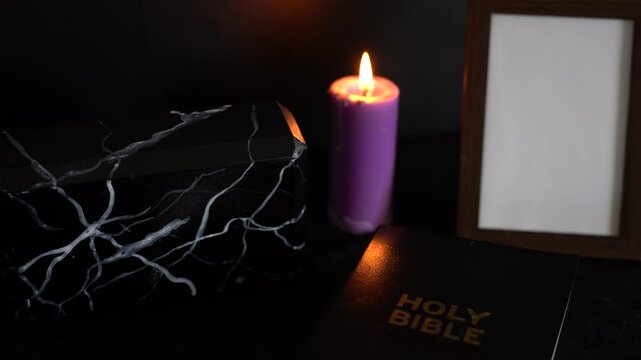       funeral, photo frame, candles, marble urn for ashes, holy bible and spiritual bracelet with black cross