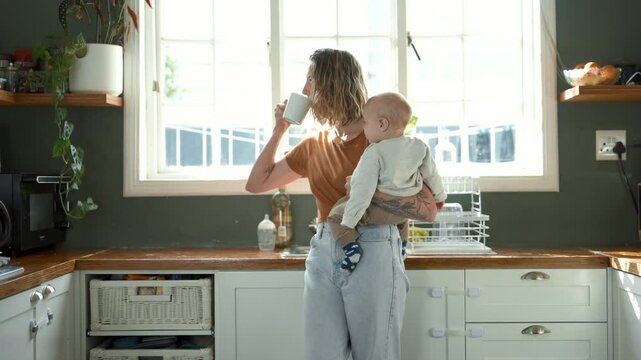 Coffee, home or mother bonding with baby in the morning with kid or care drinking espresso in apartment. Parent, tea or mom enjoying quality time with love or newborn child in family house kitchen