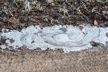 Icy puddle on a dirt road