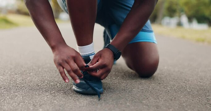 Person, hands or tie shoes with laces on asphalt for walk, run or workout at outdoor park. Closeup, active or runner with sneaker or tying for cardio training or fitness preparation on street or road