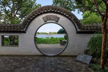 Traditional Chinese garden circular gate scene, Guozhuang at West Lake, Hangzhou, China