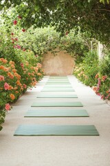 Meditative yoga practices occur within a tranquil garden adorned with vibrant flowers, gentle mats, and soothing incense enhancing the atmosphere.