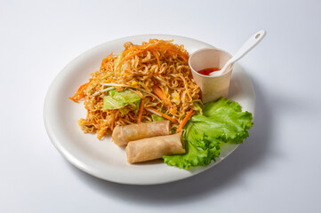Generated image Stir fried noodles with thai fried spring rolls on a plate isolated on a white background typical dish of traditional Thai cuisine
