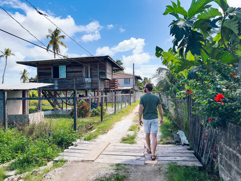 A tourist man explores a small town in Guyana