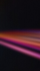 Blurred diagonal neon light streaks in orange, pink, and purple on a dark background. Ideal for wallpapers and dynamic designs.