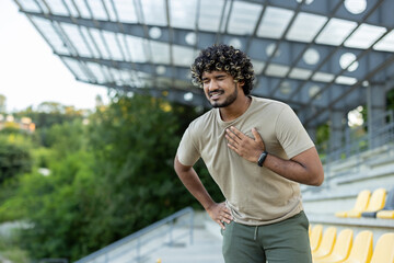 Overworked and overtired runner while doing active physical exercise and running outside in the...