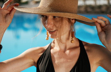 In the straw hat. Beautiful young woman is at resort, vacation