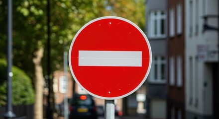 Road Sign Indicates No Entry Zone with Urban Building Backdrop
