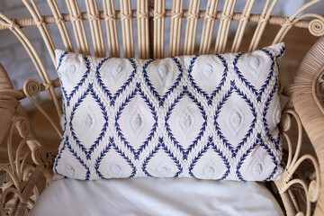 Modern boho room with interior design with rattan peacock chair. Wooden armchair with pillow in living room. Eco natural furniture. Cozy room with the wicker chair with cushion. Cozy Relax at home