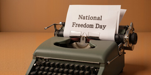 Vintage typewriter with National Freedom Day paper for historical and patriotic-themed projects