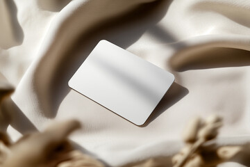 Minimalist blank business card mockup with rounded corners on textured linen backdrop