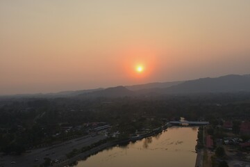 sunset into mountain at Khun Dan Prakarn Chon huge concrete dam in evening on Thailand 