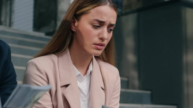 Two business people in city Caucasian happy rich man businessman male masculine counting salary money sad woman female girl businesswoman frustrated with cash financial unequal rights injustice sexism
