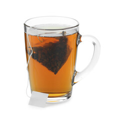 Tea bag in glass cup with hot drink isolated on white