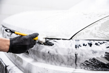 Thorough hand cleaning of car elements using a precise brush ensures spotless shine and attention to every detail