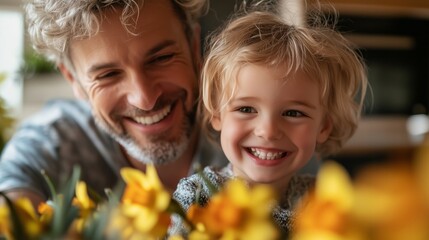 Portrait of a happy man with a little blond boy, in front of them is a bouquet of daffodils. Concept: family day, St. David's Day, symbol of spring