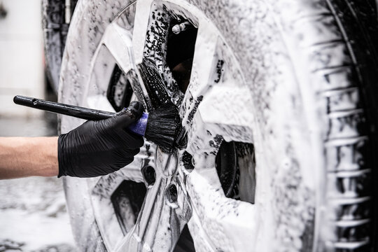 Thorough wheel cleaning with a detailing brush ensures spotless rims and a professional finish in every inch