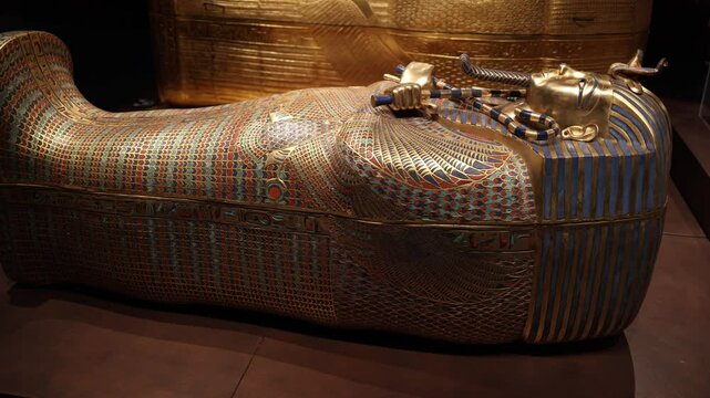 The ornately decorated sarcophagus of Pharaoh Tutankhamun, adorned with gold, lapis lazuli, and intricate inlays. This masterpiece embodies the splendor of ancient Egyptian burial traditions.