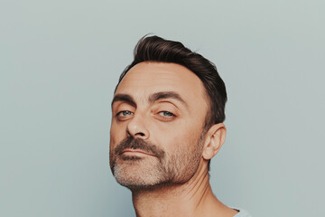 Studio portrait of middle aged man with facial hair, neutral gray background