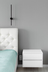 A minimalist elegant modern bedroom featuring a sleek bed, natural color tones, and a bright window overlooking an outdoor area. Interior Minimalist Design