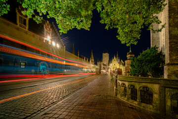 Streaks of light from public transport passing on Sint Michelsplein Bridge (Ghent), Belgium. The impressive entrance to the monumental city center with Urban city scape in Flanders.
