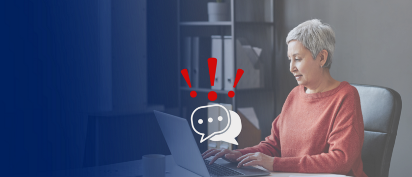 senior lady working on her laptop; chat symbols layer with red question marks on her computer; concept online threats like credit card fraud, cyberthieving for older people; copy space