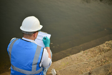 An environmental expert is conducting a thorough examination of the contaminants and aquatic life...