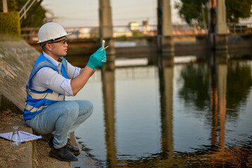An environmental expert is collecting water samples to study the environment and the health of the...