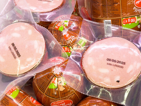 Packaged mortadella slices with expiry date in clear plastic wrap