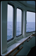 Serene view from a ship's bridge, with three windows 